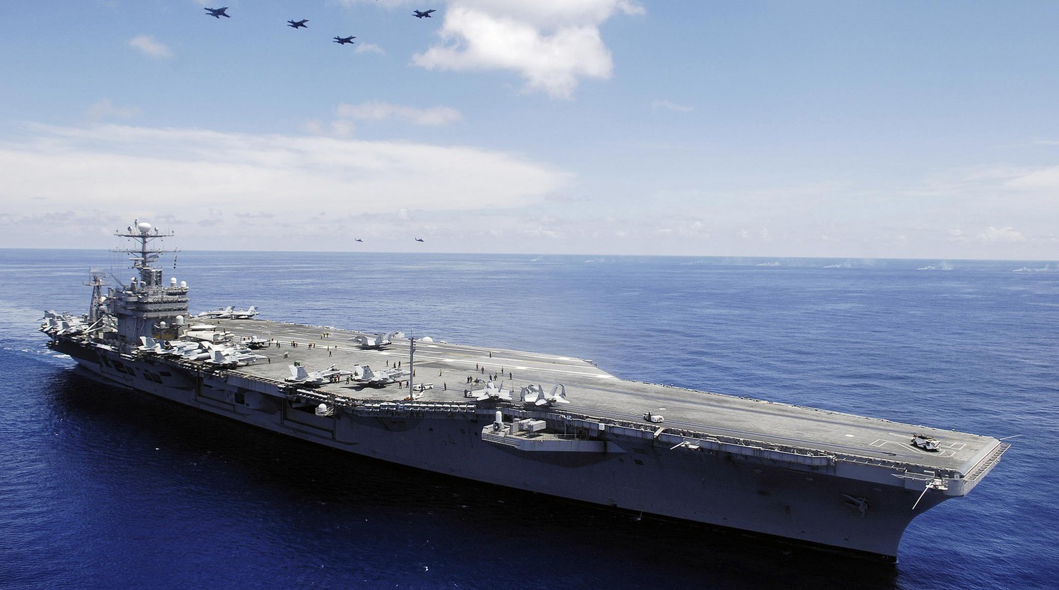 U.S. Carrier and Iran in Escalating Standoff Amid Missile Threats