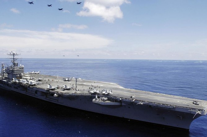 U.S. Carrier and Iran in Escalating Standoff Amid Missile Threats
